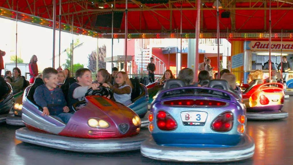 Lachende Kinder beim Autoscooter fahren